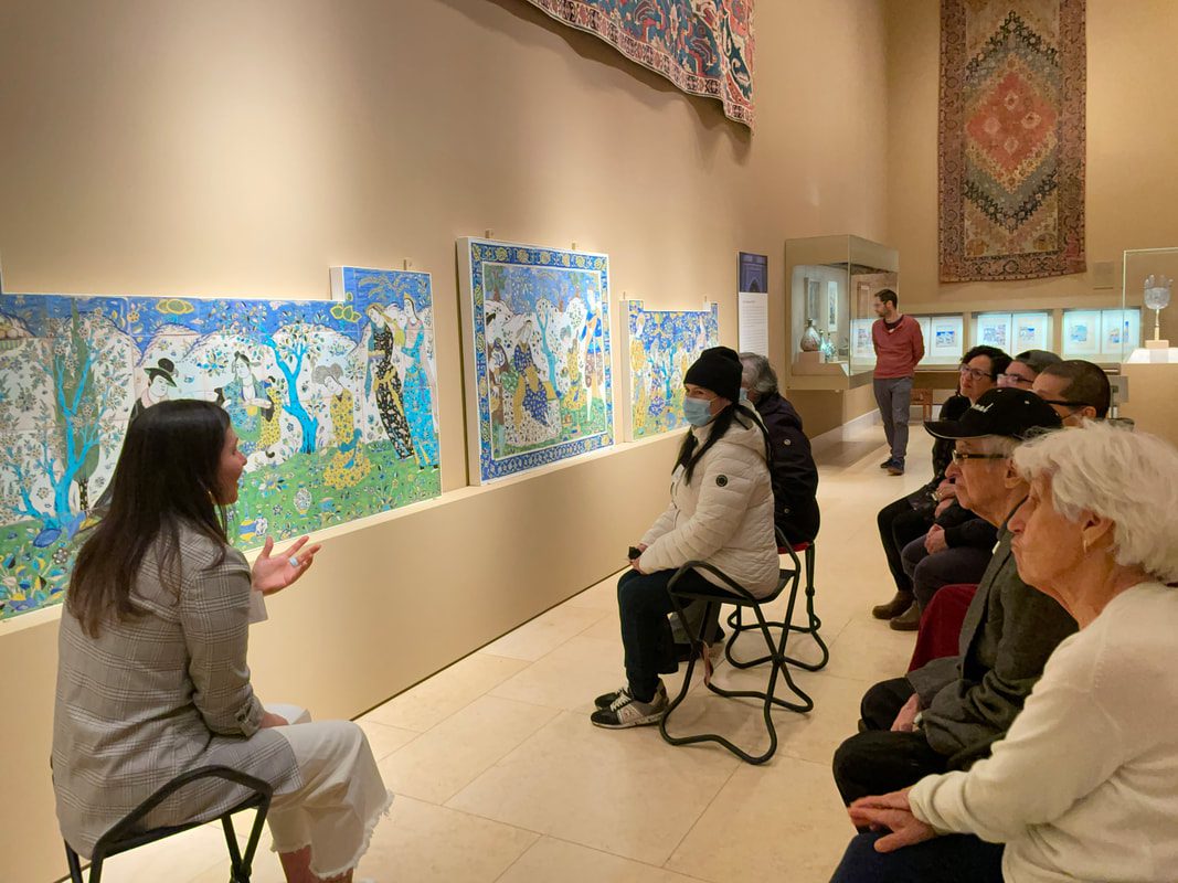 Visitors observing vibrant artwork in museum