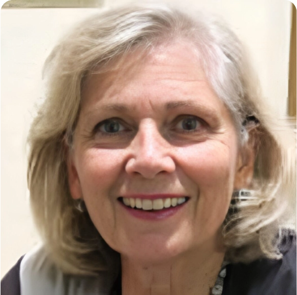 Smiling elderly woman with gray hair indoors.