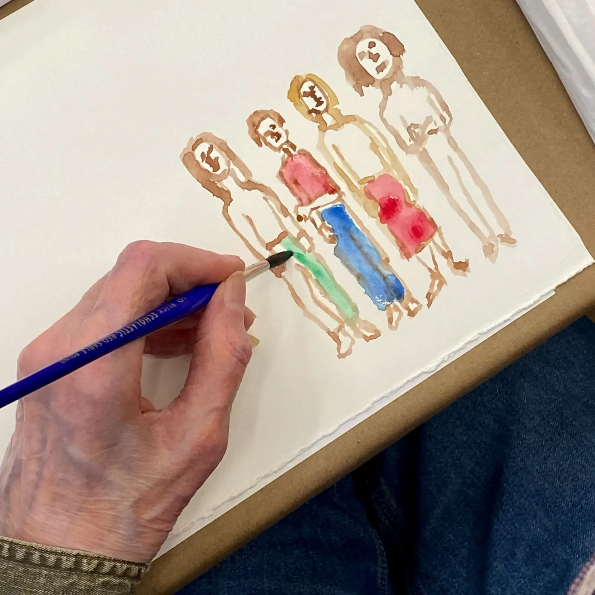 Hand painting figures with a blue brush.