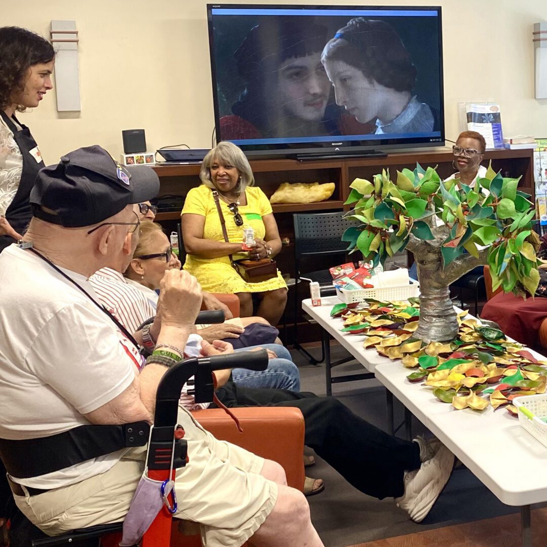 Group gathered around table with crafts.