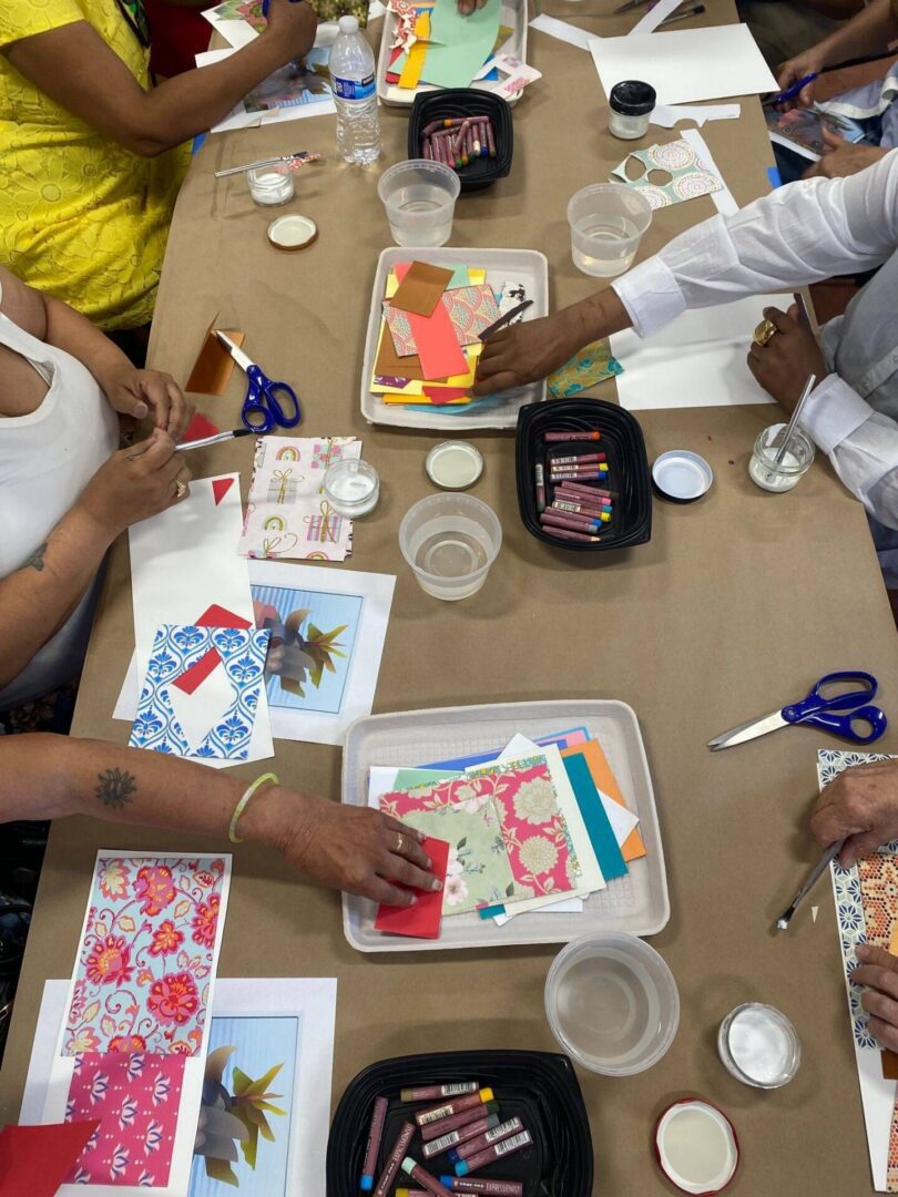 People crafting with colorful paper and supplies.