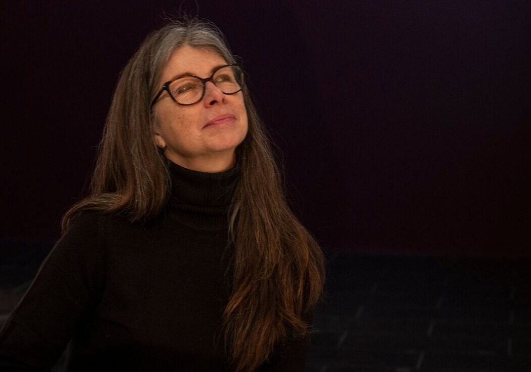 Content woman with long hair and glasses